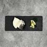 Patagonian Toothfish in 50g portion on slate with lemon slices and herbs in Singapore (flatlay).