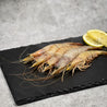 Seafrozen Western Australian Banana Prawn on slate with lemon slices in Singapore.