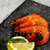 Cooked Vannamei Prawn on slate with lemon slices and herbs in Singapore.